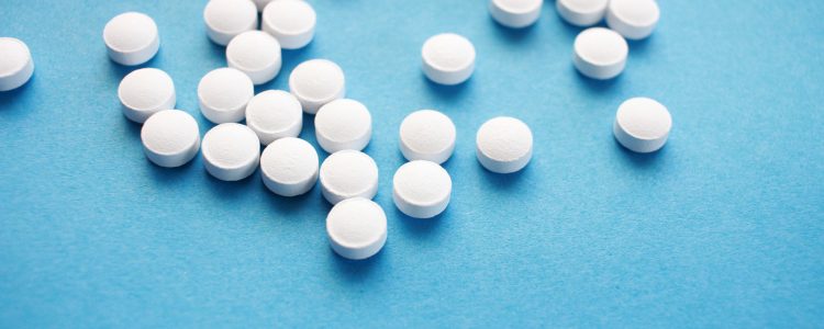 Tablets scattered on a blue surface