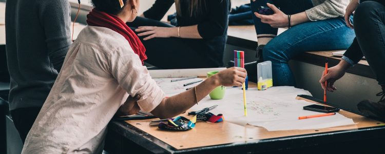 Students working on a project together around a table