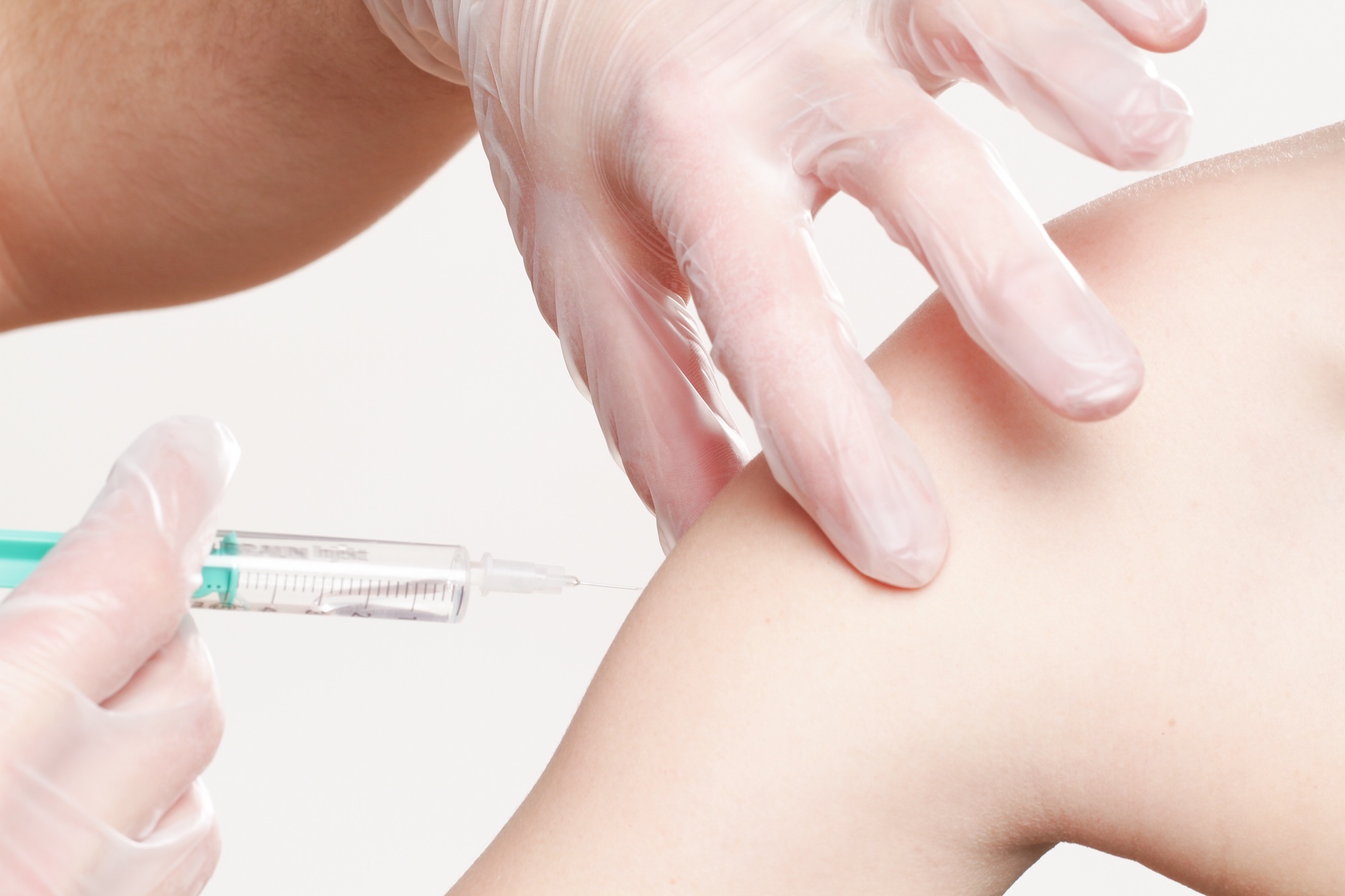 Doctor administering a vaccination into an arm