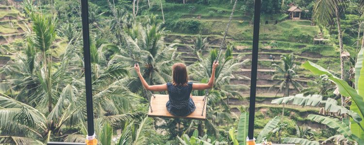 Woman using a swing in the jungle