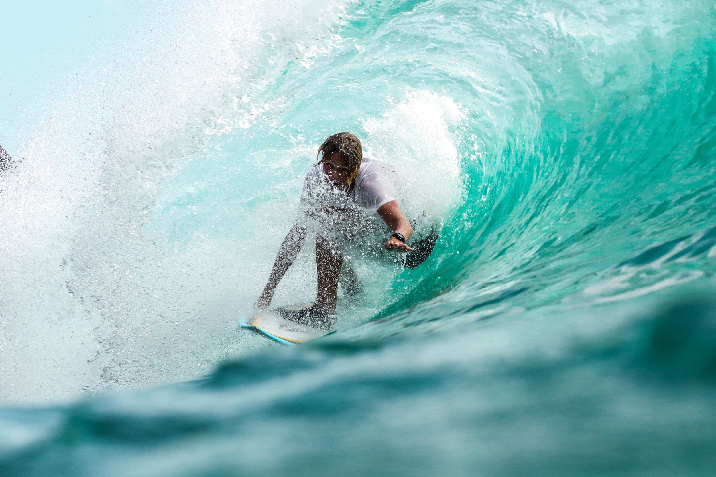 A man surfing a wave in Bali, Indonesia