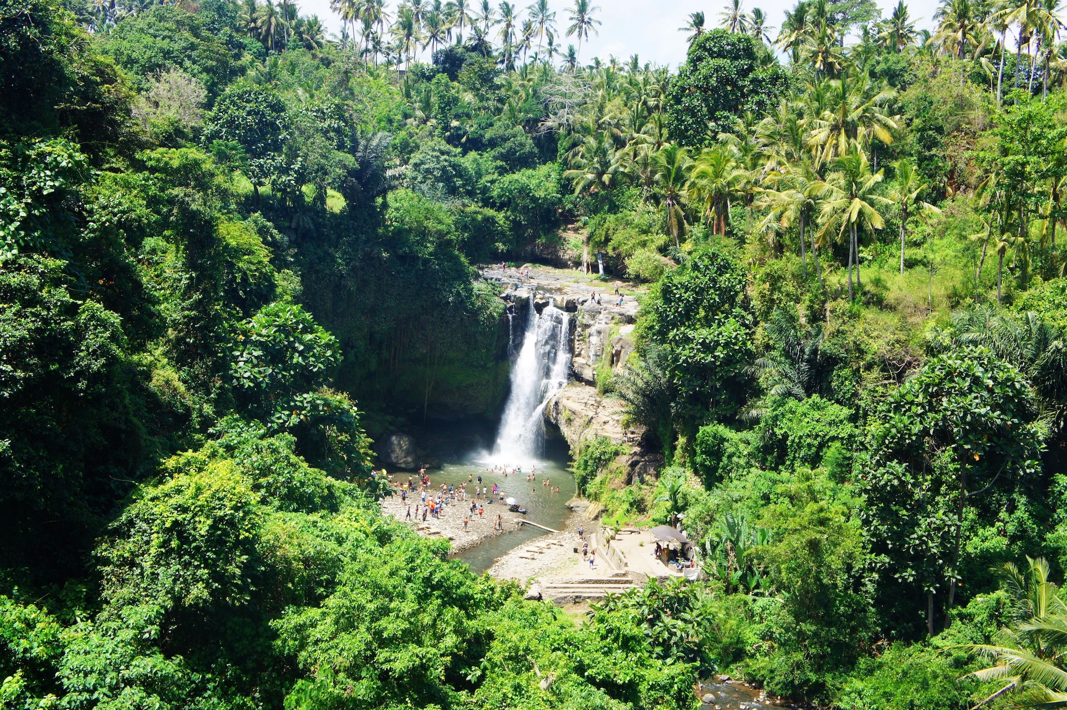 Aerial view of people at a waterfall in the jungle in Bali