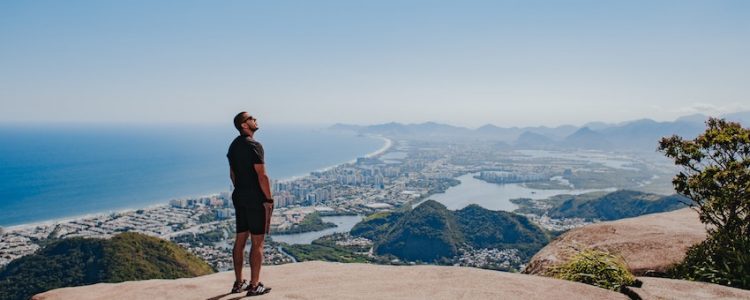 Man standing alone looking down over town