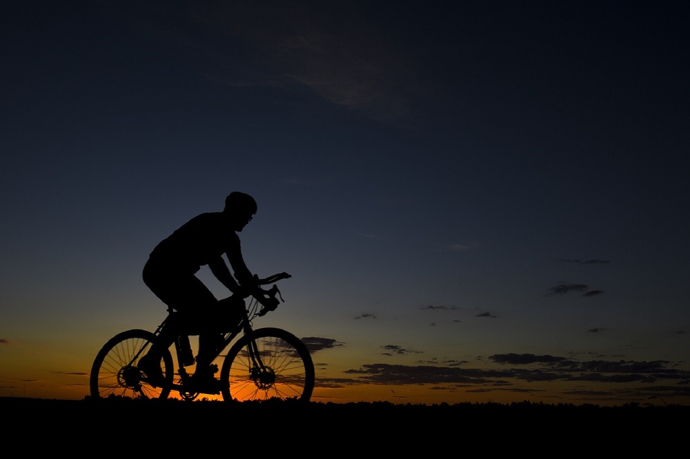 Man cycling at sunset