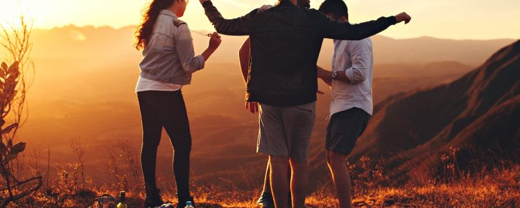 Group of friends at sunset on a hillside