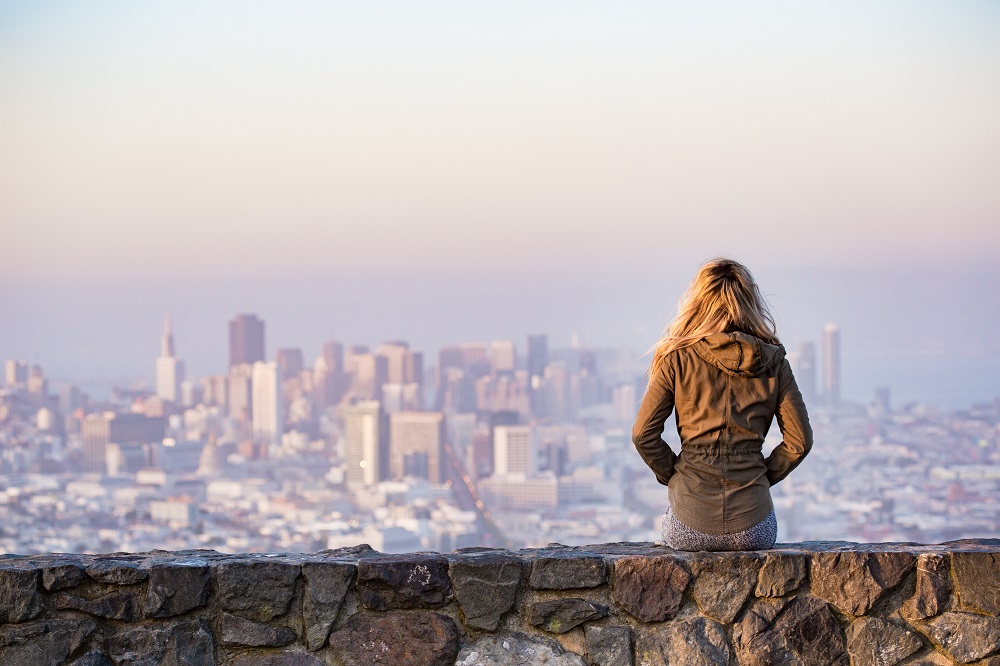 Woman sitting overlooking a cityscape