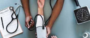 Doctor taking patients blood pressure