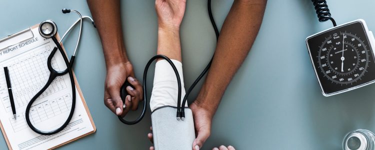 Doctor taking patients blood pressure