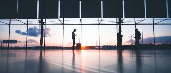 People wait at an airport boarding gate