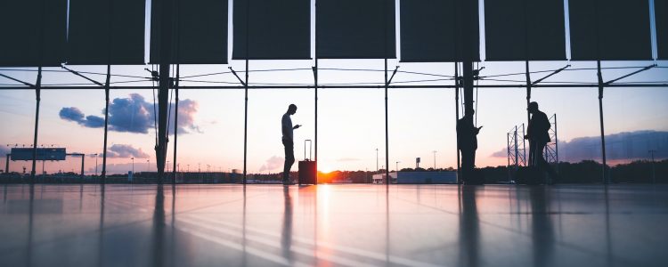 People wait at an airport boarding gate