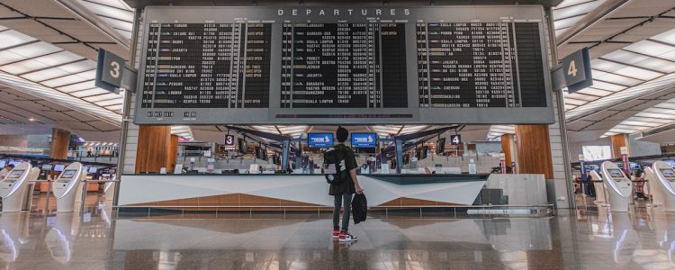 A person looks at an airport departures board