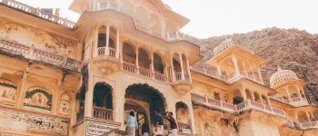 People enter an ornate stone building in India