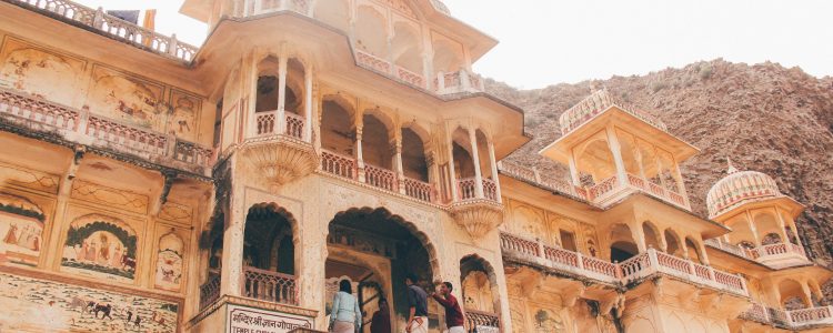 People enter an ornate stone building in India